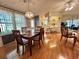 Dining room showcasing a wood table set for four, open to kitchen and living areas at 175 Hibiscus Way, Leesburg, FL 34748