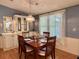 Charming dining room with a wooden table set for four, and classic decor at 175 Hibiscus Way, Leesburg, FL 34748