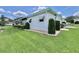 A single-story home with well-maintained landscaping around the perimeter on a grassy lawn at 175 Hibiscus Way, Leesburg, FL 34748