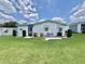 Charming single-story home featuring a well-manicured lawn and neatly trimmed landscaping at 175 Hibiscus Way, Leesburg, FL 34748