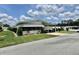 Well-maintained home exterior with manicured greenery and a neatly paved driveway at 175 Hibiscus Way, Leesburg, FL 34748