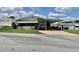 Attractive home with a covered carport and manicured lawn in a well-maintained community at 175 Hibiscus Way, Leesburg, FL 34748