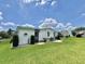 Single-story home with neat landscaping around the perimeter on a well-maintained lawn at 175 Hibiscus Way, Leesburg, FL 34748