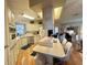 A modern kitchen with white cabinets, stainless steel appliances and a large island at 175 Hibiscus Way, Leesburg, FL 34748