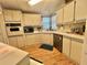 The kitchen features stainless steel appliances, modern cabinets, and hardwood flooring at 175 Hibiscus Way, Leesburg, FL 34748