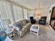 Sunroom featuring a sofa, recliners, and abundant natural light at 175 Hibiscus Way, Leesburg, FL 34748