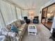 Relaxing sunroom with plush seating, a chess table, and sliding doors to the exterior at 175 Hibiscus Way, Leesburg, FL 34748