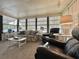 Bright living room with comfortable seating, large windows, and a chessboard at 175 Hibiscus Way, Leesburg, FL 34748