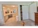 Main bedroom with ensuite bathroom featuring a spacious closet and neutral carpet at 175 Hibiscus Way, Leesburg, FL 34748