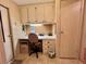 Bright office space featuring built-in desk, cabinets, and storage for efficient home management at 175 Hibiscus Way, Leesburg, FL 34748