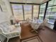 Cozy sunroom with abundant natural light, ceiling fan and space for dining and lounging at 175 Hibiscus Way, Leesburg, FL 34748