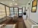 Relaxing sunroom with a ceiling fan and large windows, perfect for enjoying natural light at 175 Hibiscus Way, Leesburg, FL 34748