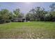 Expansive backyard with a shed, privacy fence, and mature landscaping at 18015 Palm St, Umatilla, FL 32784