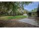 Large backyard features a shed, mature trees, and a concrete patio at 18015 Palm St, Umatilla, FL 32784