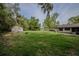 The expansive backyard features a shed, a fire pit, and mature trees at 18015 Palm St, Umatilla, FL 32784