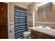 Bathroom features a blue-striped shower curtain and cabinet for linens and toiletries at 18015 Palm St, Umatilla, FL 32784
