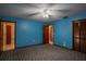 This bedroom has bright blue walls and patterned carpeting at 18015 Palm St, Umatilla, FL 32784