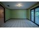 Comfortable bedroom with green walls, tile floor, and sliding glass doors that provide natural light at 18015 Palm St, Umatilla, FL 32784