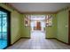 Dining area leads to kitchen featuring tile floor, skylight, and convenient pass-through to kitchen at 18015 Palm St, Umatilla, FL 32784