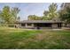 Charming brick home features a spacious yard, mature trees, and a screened porch at 18015 Palm St, Umatilla, FL 32784