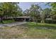 Landscaped front yard and driveway leading up to this home at 18015 Palm St, Umatilla, FL 32784