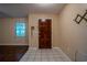 Foyer with tile floor, dark wood door, and coat rack at 18015 Palm St, Umatilla, FL 32784