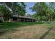 Charming single-story brick home with lush landscaping and mature trees at 18015 Palm St, Umatilla, FL 32784