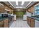 Kitchen with stainless steel appliances and ample wood cabinets opening to dining area at 18015 Palm St, Umatilla, FL 32784