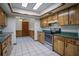 Kitchen featuring ample cabinets, stainless steel appliances, tile floors, and convenient access to dining area at 18015 Palm St, Umatilla, FL 32784