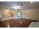 Bright living room with unique flooring, ceiling fan, and open entryway at 18015 Palm St, Umatilla, FL 32784