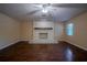 Spacious living room featuring a decorative fireplace and a window providing natural light at 18015 Palm St, Umatilla, FL 32784