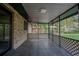 Relaxing screened patio features neutral tile flooring and lattice privacy screening at 18015 Palm St, Umatilla, FL 32784