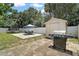 Spacious backyard with a patio, grill, shed, and privacy fence, perfect for outdoor entertaining and activities at 1805 Jefferson Dr, Mount Dora, FL 32757