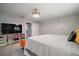 Relaxing bedroom space illuminated by chandelier with large bed and mirrored dresser at 1805 Jefferson Dr, Mount Dora, FL 32757