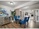 Elegant dining room featuring a glass table, blue velvet chairs and wood floors at 1805 Jefferson Dr, Mount Dora, FL 32757