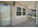 Close-up of home entrance featuring modern door, window, and carport at 1805 Jefferson Dr, Mount Dora, FL 32757