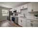 Bright kitchen with white cabinets, stainless steel appliances, and quartz countertops at 1805 Jefferson Dr, Mount Dora, FL 32757