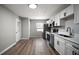 Open kitchen with stainless steel appliances and a view to an exterior door at 1805 Jefferson Dr, Mount Dora, FL 32757