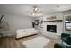 Bright living room featuring a white brick fireplace, white sofa, and modern decor at 1805 Jefferson Dr, Mount Dora, FL 32757