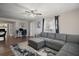 Comfortable living room area featuring a gray sofa, modern ceiling fan and a stylish desk area at 1805 Jefferson Dr, Mount Dora, FL 32757