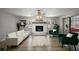 Bright living room featuring a white brick fireplace, white sofa, and modern decor at 1805 Jefferson Dr, Mount Dora, FL 32757
