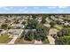 Aerial view of a home with mature landscaping in a quiet neighborhood surrounded by trees at 2003 Cordero Ct, The Villages, FL 32159