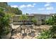 Outdoor seating area surrounded by lush plants and tropical trees next to a covered lanai at 2003 Cordero Ct, The Villages, FL 32159