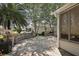 Lovely backyard features pavers, mature trees, outdoor lights, and a screened in sunroom at 2003 Cordero Ct, The Villages, FL 32159