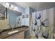 Light blue bathroom with vanity, floral shower curtain and tile flooring at 2003 Cordero Ct, The Villages, FL 32159