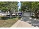 Charming home with a well-manicured lawn, mature trees, and a two-car garage offers great curb appeal at 2003 Cordero Ct, The Villages, FL 32159