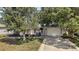 Charming home with well-manicured landscaping, a blue awning, and a cozy front patio at 2003 Cordero Ct, The Villages, FL 32159