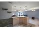 Spacious kitchen layout with bar seating, stainless appliances, and seamless transition into living areas at 2003 Cordero Ct, The Villages, FL 32159