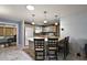 Well-lit kitchen featuring bar seating, modern appliances, and views into the living space at 2003 Cordero Ct, The Villages, FL 32159