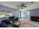 Inviting living room with a comfortable sofa, modern ceiling fan, and ample natural light at 2003 Cordero Ct, The Villages, FL 32159
